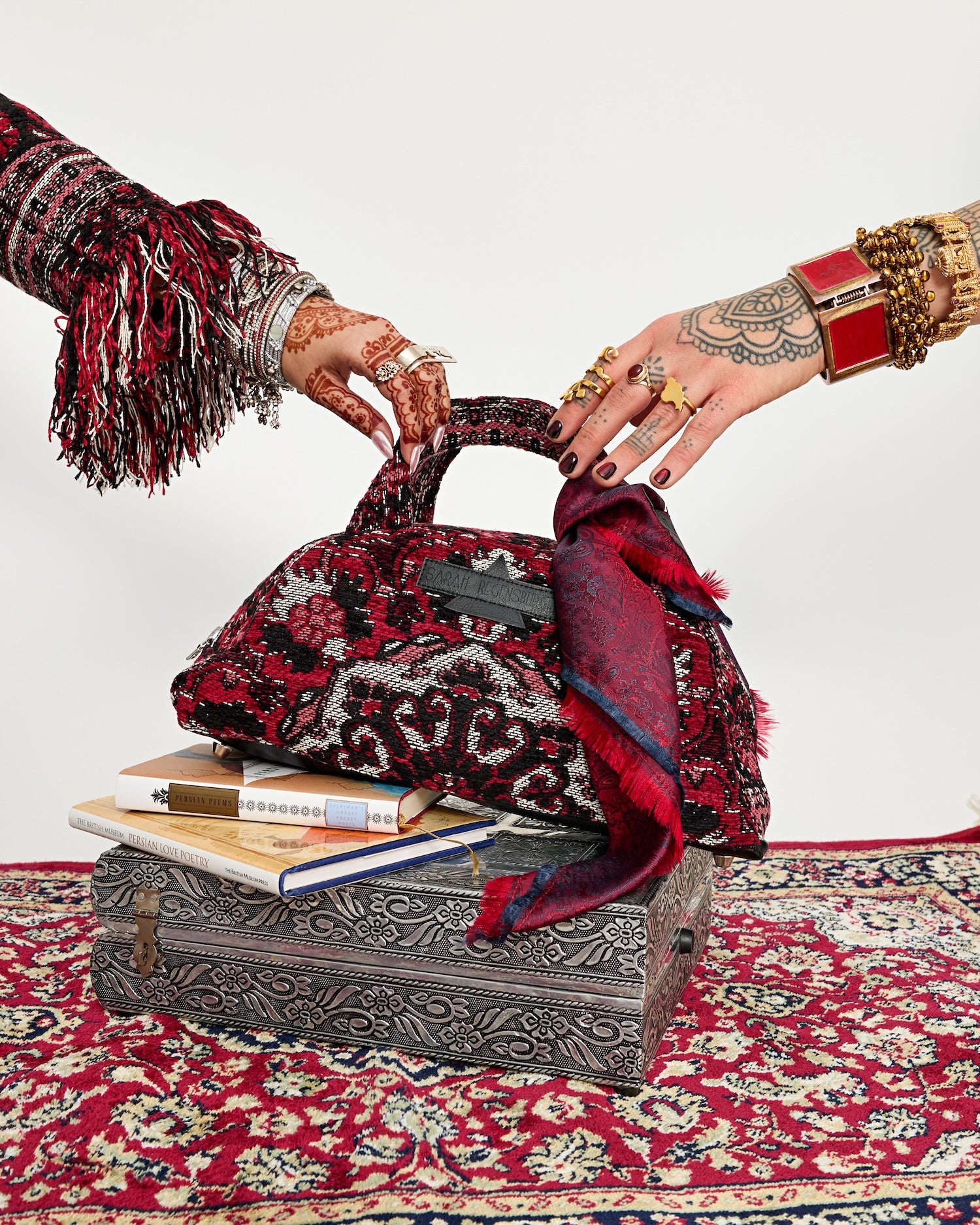 Two hands meeting over the Azadi Bag