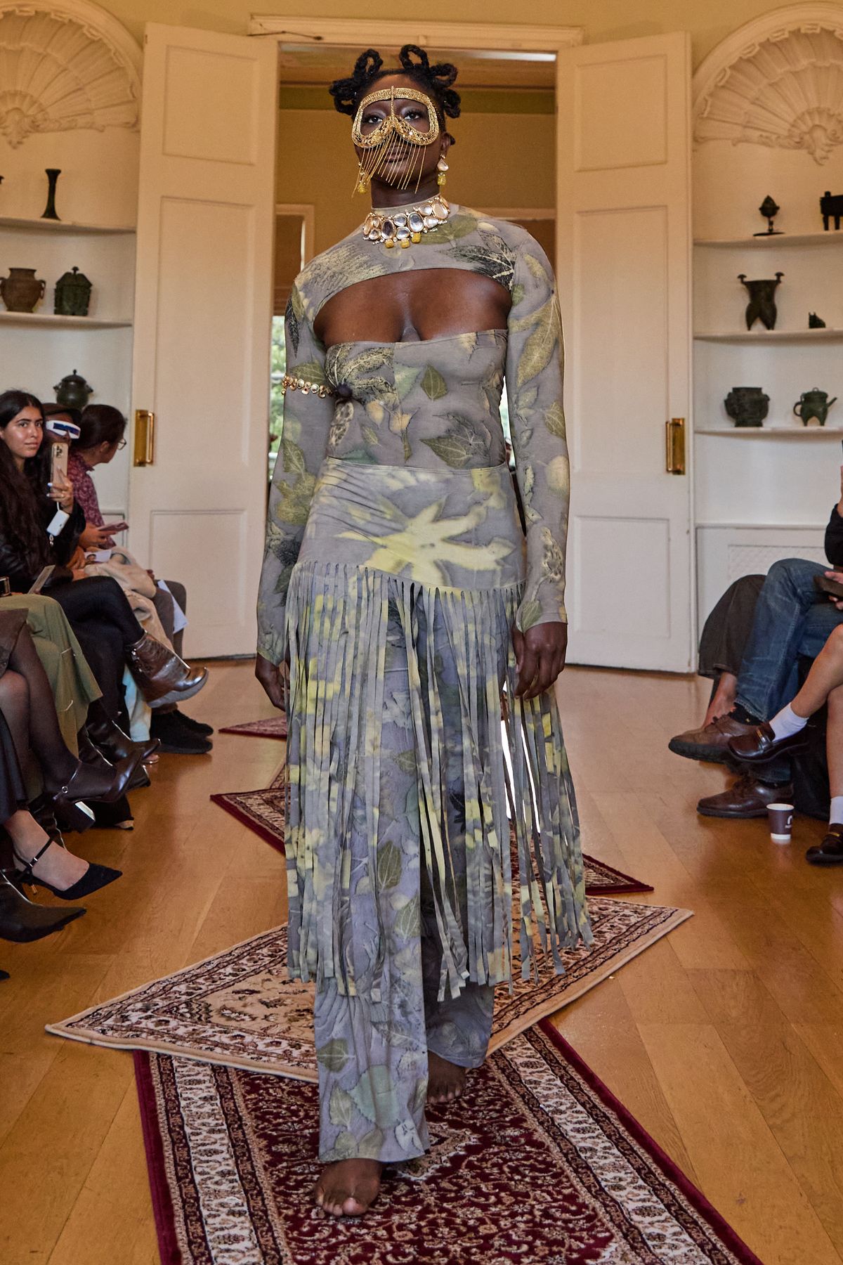 Leaf print catsuit and separate fringe skirt on the London runway